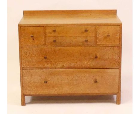 A Heal's 1930s limed oak ledge back chest, having an arrangement of four short upper drawers over twin long lower drawers, wi