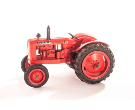 A Denzil Skinner Nuffield Universal Tractor, large scale model, dark orangey red body, black rubber tyres, exhaust and air cl