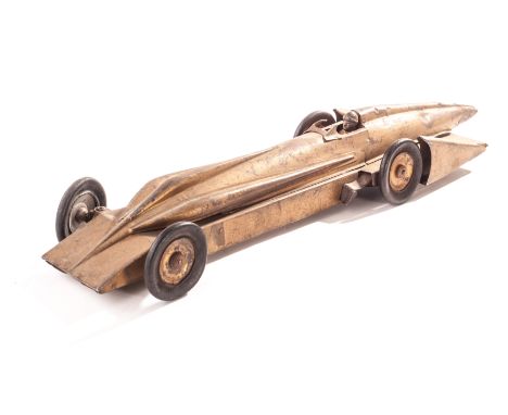 A Kingsbury tinplate model of Sir Henry Segrave’s Golden Arrow land speed record car, in gold, P-F, general paint loss, lacks