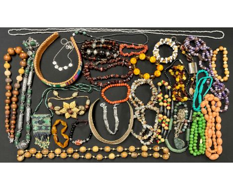 A mixture of Costume Jewellery;to include; a metal torque choker, wooden bead necklaces, a beaded purse and a quartz/agate be