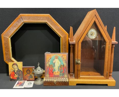 A mahogany architectural tabernacle, pointed-arch top, hinged glazed door, containing icons, etc, 51cm high; an octagonal tab