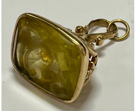 A 9ct gold mounted paste stone watch fob,set with a rectangular cushion cut pale yellow paste stone measuring approx. 19mm (L