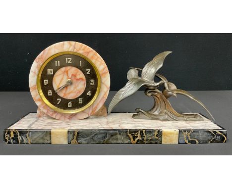 An Art Deco onyx mantel clock, the circular dial with Arabic chapter ring, single winding hole to movement, the case mounted 