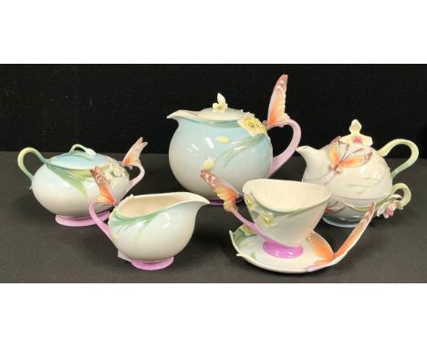 A Franz porcelain teapot with butterfly handle XP1878, similar sucrier and cover XP1877, milk jug XP1947; a Franz teacup and 