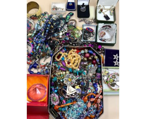 A collection of costume jewellery and two diamond shaped glass paperweights boxed, the costume jewellery includes metal, cera