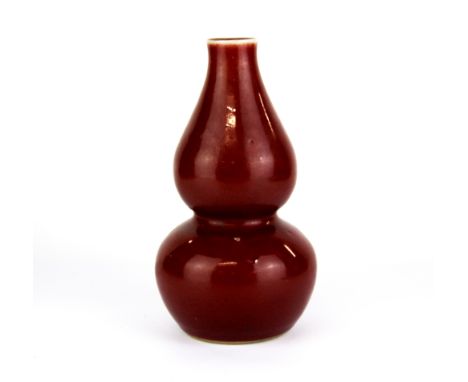 A Chinese Sang De Boeuf glazed porcelain gourd shaped vase, H. 21cm. Six character mark to base for Kangxi 1662 -1722, but pr