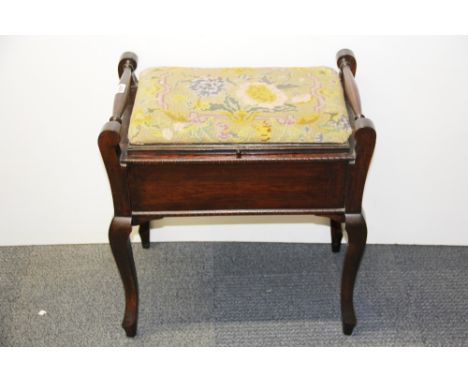 A tapestry covered piano stool.