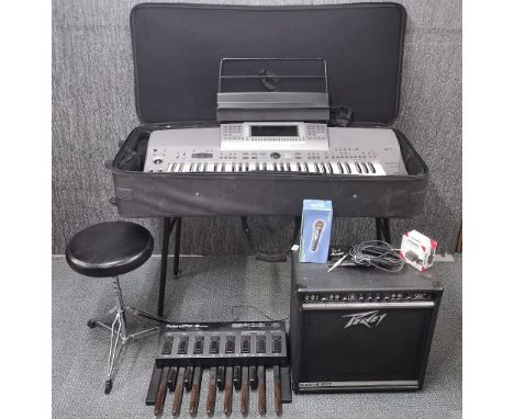 A Technics SX-KN6000 electric keyboard together with a Rowland PK-5 dynamic midi pedal keyboard, stand, amplifier and stool.