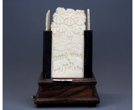 An early 20th C carved ivory panel table lamp mounted on a rosewood base, H. 20cm.