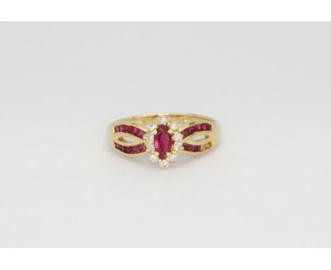 A yellow metal (tested minimum 9ct) ring set with an oval cut ruby surrounded by diamonds and ruby set shoulders, (two stones