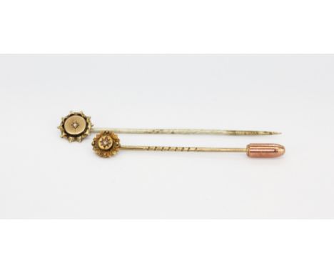 Two antique yellow metal (tested minimum 9ct gold) diamond set stick pins, one with metal pin, largest L. 6cm.