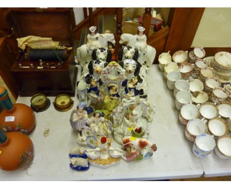 A collection of various Staffordshire flat back ornaments and spaniels
