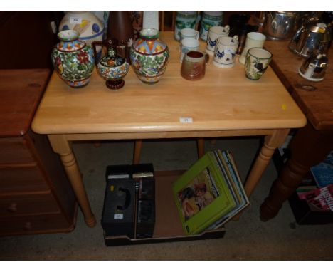 A beech kitchen table with a pair of stick back chairs 