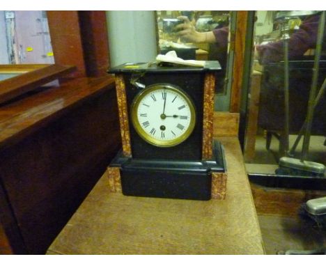 A late Victorian black slate single hole mantel clock 