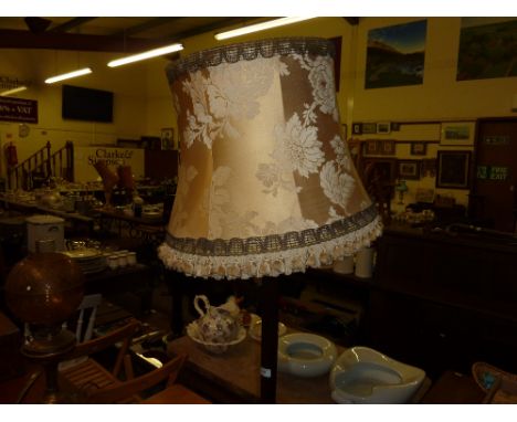 A mahogany standard lamp and shade 