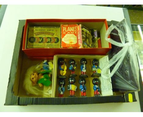 A tray containing playing cards, Golly figures, various games etc. 