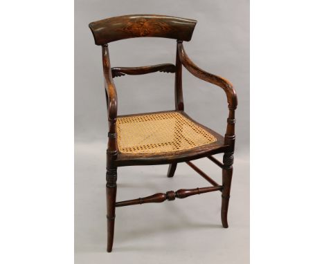 A late Regency faux rosewood open arm elbow chair, with cane seat, on ring turned legs.
