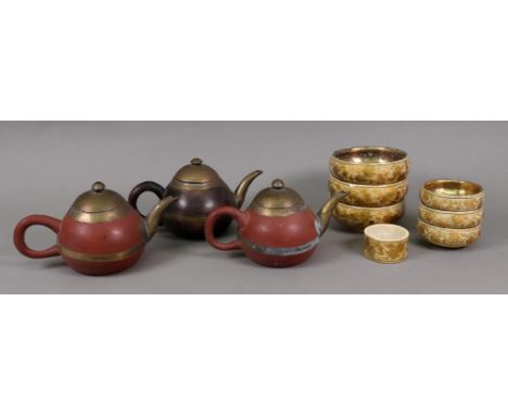 A set of three Kashmiri gilt metal and painted papier mache finger bowls, decorated with fruiting branches, 10cm diameter, wi