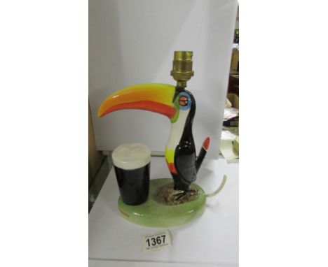 A Carlton ware toucan table lamp (a/f, beak glued back on) 21.5 cm tall.