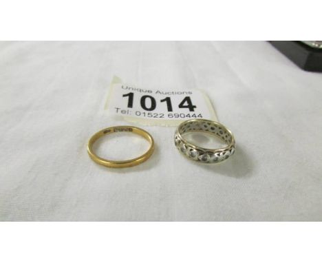 A 22ct gold wedding ring, size L, 2.1 grams and a 9ct gold eternity ring size L.