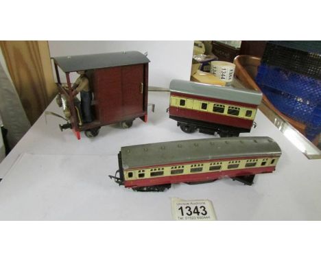 A tin plate railway carriage, a Triang railway carriage and a home built engine.