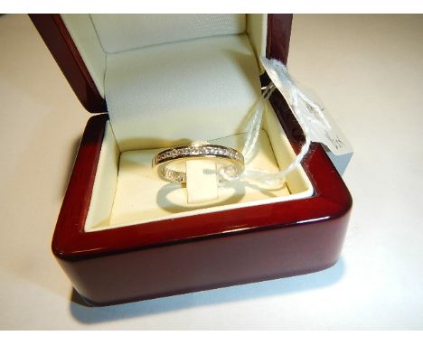 An 18ct gold wedding ring set diamonds, size O, 5 grams.