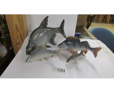Four ceramic fish all marked Denmark.*Condition report*Small fish has a chip to the bottom fin.Length of largest fish 23cm