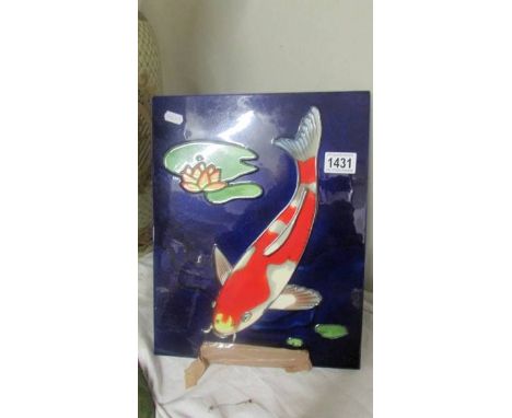 A ceramic wall plaque depicting koi carp. 36 x 28 cm.&nbsp;