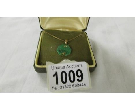 A jade pendant on a 9ct gold chain, 4 grams.