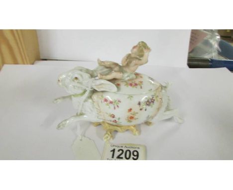 A 19th century procelain trinket pot of a cherub riding a hare with blue Y mark, in good condition.