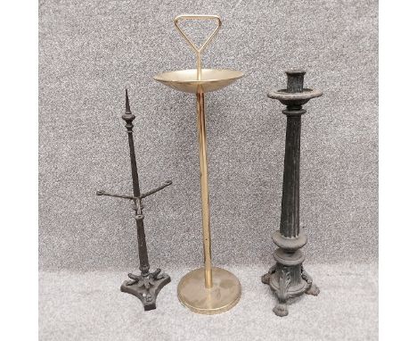Three items to include a 19th century cast iron fireside tool stand, an early 20th century brass Art Deco ashtray, and a 19th