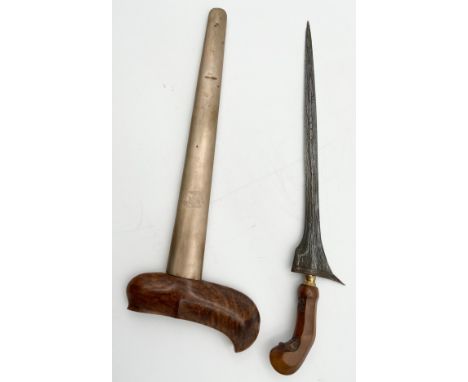 An Indonesian style Kris knife with a carved hardwood handle and white metal blade and scabbard. L.49cm.