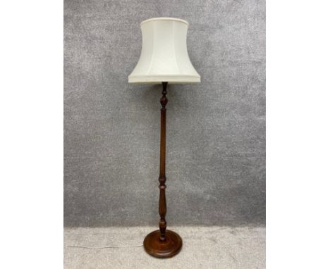 An early 20th century turned and fluted mahogany standard lamp with shade. H.182cm