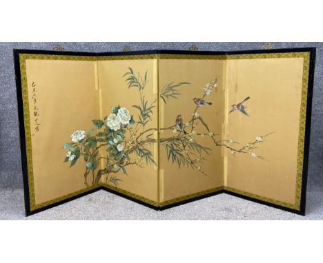 A Chinese screen with hand painted gouache birds and plum blossom on silk with calligraphic characters across four folding pa