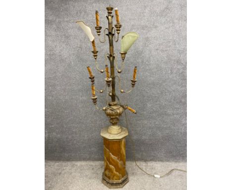 A 19th century floor lamp with a carved and gilt candlestick top, above two pairs over two sets of three graduating gilt iron