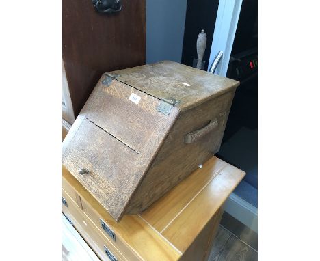 An oak coal scuttle with tools. 