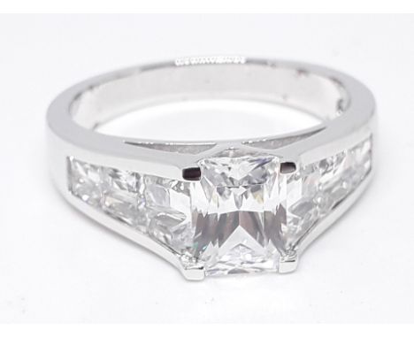 A silver ring set with rectangular cut colourless stones, marked '925 DQCZ', size U, with box. 