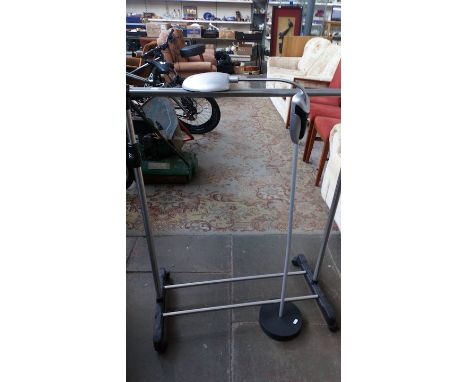 A clothes rail and a reading lamp 