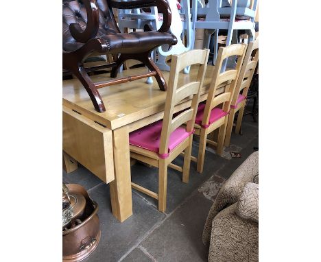 A light wood extending dining table with six ladder back chairs. 