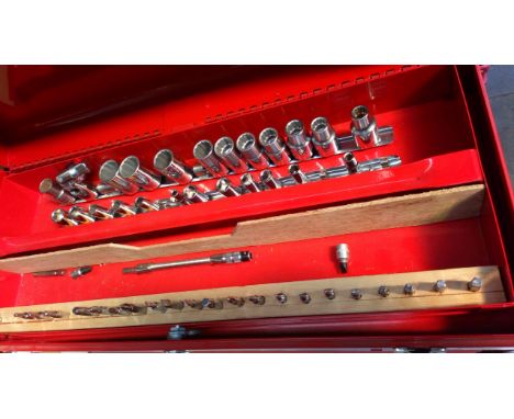 A red metal toolbox with tools 