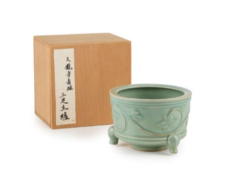  CHINESE CELADON-GLAZED 'PEONY' TRIPOD INCENSE BURNER YUAN DYNASTY OR LATER 元或以後 青釉牡丹紋三足爐of cylindrical form supported on thr