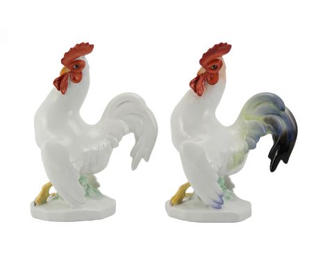 A near pair of 20th century Herend porcelain white cockerels, heightened with red wattle and comb, nr 5014/2, approx 24 cms, 