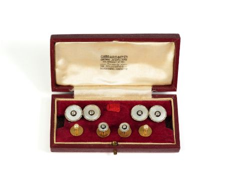 Garrard & Co 9ct gold and mother of pearl dress studs heightened with a single diamond surround by enamel, comprising four dr