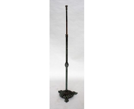 A late Victorian brass and cast iron standard lamp, in the Regency style, the adjustable stem on scalloped base, raised on th