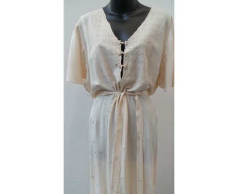 A beautiful 1920's cream silk dress with sash.  This garment has a deep V to front and back with fine embroidery work to bodi