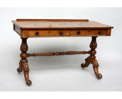 A Victorian walnut sofa table, rectangular top over two frieze drawer, on fluted tapering supports, with turned central stret