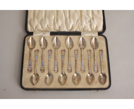 An Art Deco set of twelve silver and enamel tea spoons, cream jug and sugar castor, by Barker Bros. Ltd., Birmingham 1928, th