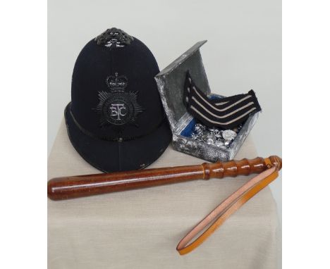 A vintage 1960's British Transport Policemans helmet, truncheon, stripes,buttons and badges. (Qty)