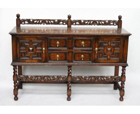 A William & Mary style oak sideboard, foliate carved top rail with turned finial's, over rectangular top, above an arrangemen