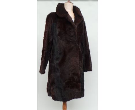 A dark brown fur coat and a vintage faux fur jacket, a beige stole and a selection of fur tippets and hats. (9)